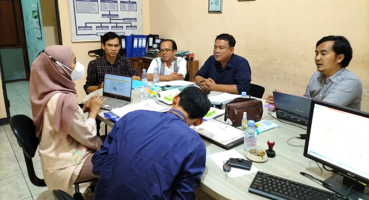Happy mature professor and her students talking at university classroom.